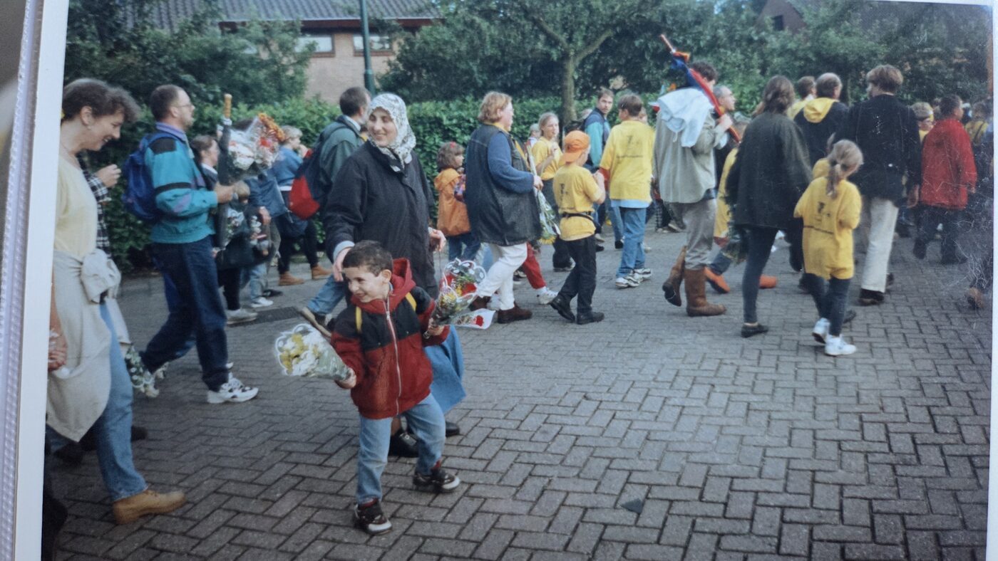 Mustafa running with flowers at parade